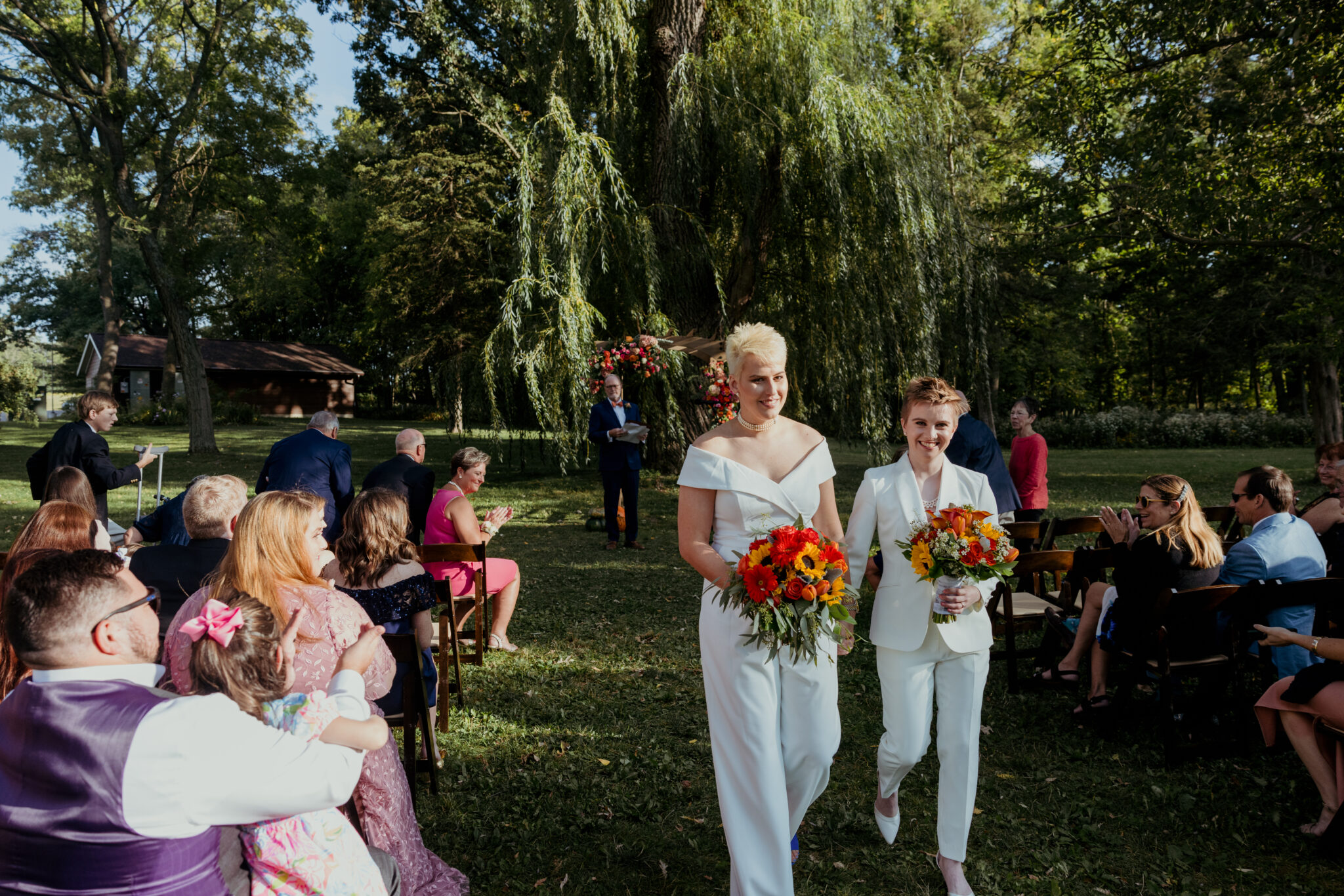 Outdoor wedding ceremony under willow tree